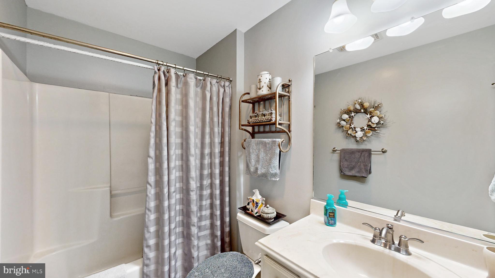 11872 Shawnee Road Greenwood, DE 19950 - Photo 20 of 55 a bathroom with a sink mirror and a shower