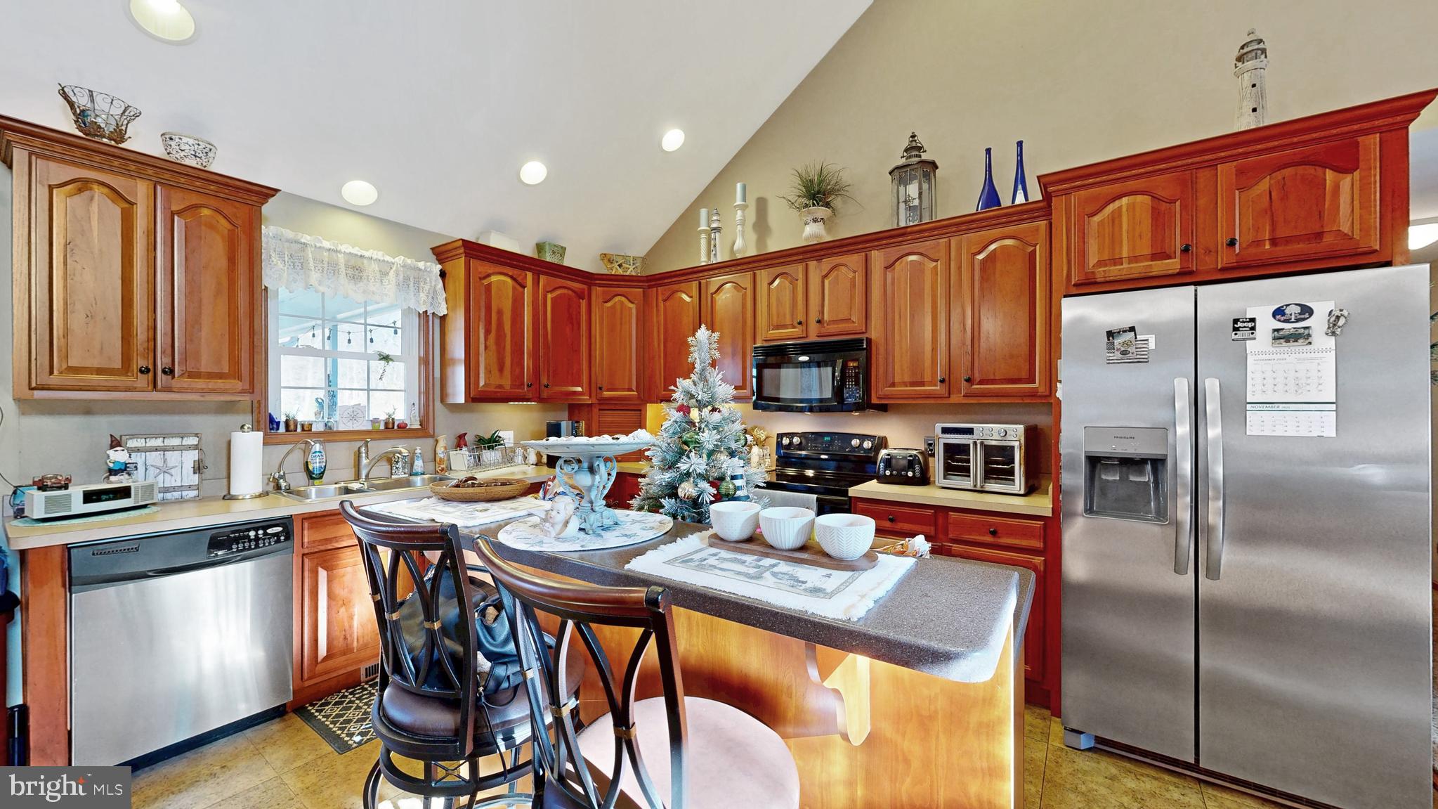 11872 Shawnee Road Greenwood, DE 19950 - Photo 32 of 55 a kitchen with stainless steel appliances granite countertop a refrigerator a sink a stove a microwave and dining table