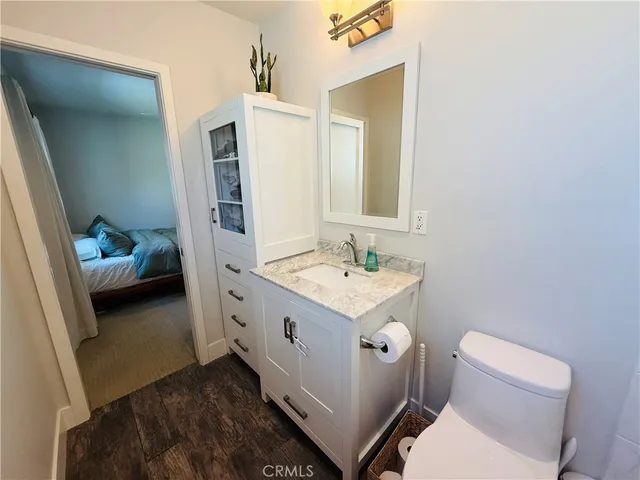 a bathroom with a sink toilet and mirror