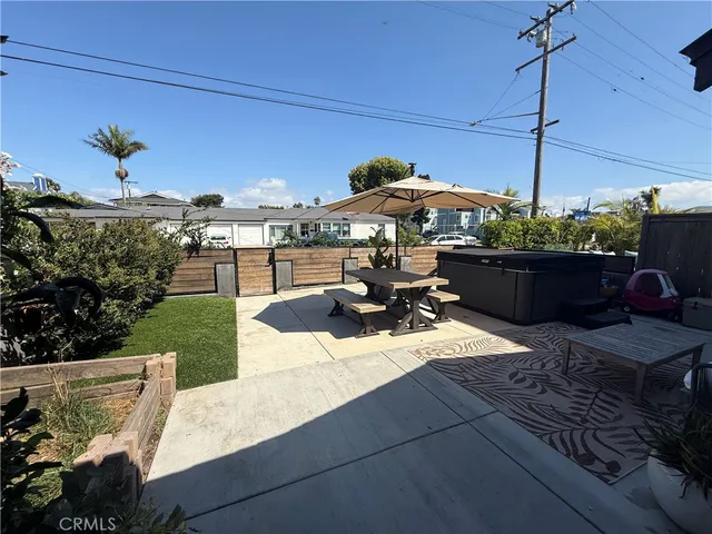a view of a patio with couches table and chairs potted plants