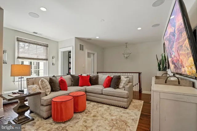 a living room with furniture and a lamp