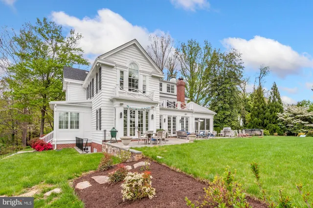 a front view of a house with a yard table and chairs
