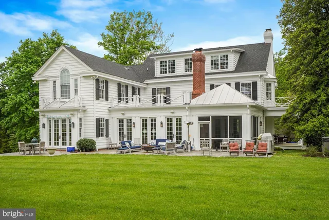 a front view of a house with a yard table and chairs
