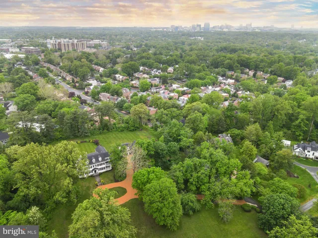 an aerial view of a residential houses with yard and swimming pool
