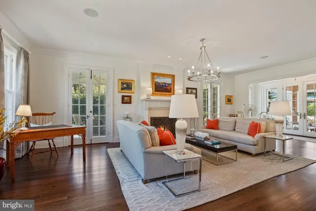 a living room with furniture and a chandelier
