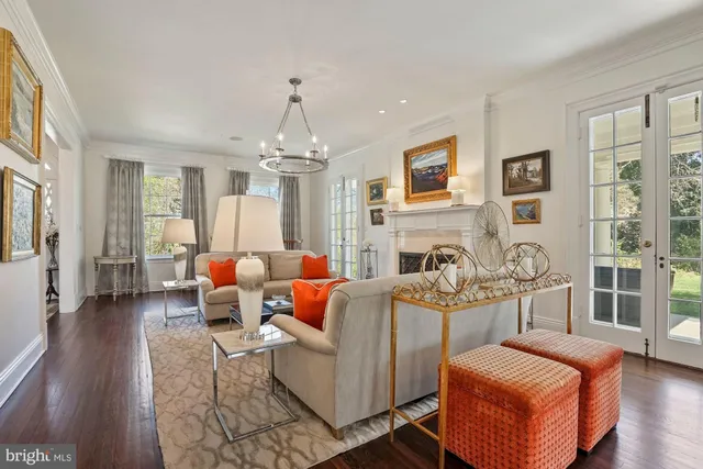 a living room with fireplace furniture and a wooden floor