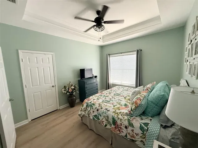 a bedroom with a bed and a chandelier