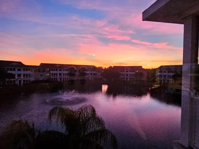 a view of swimming pool outdoor seating and lake view