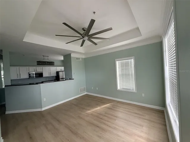 a view of a kitchen with a sink cabinets and wooden floor