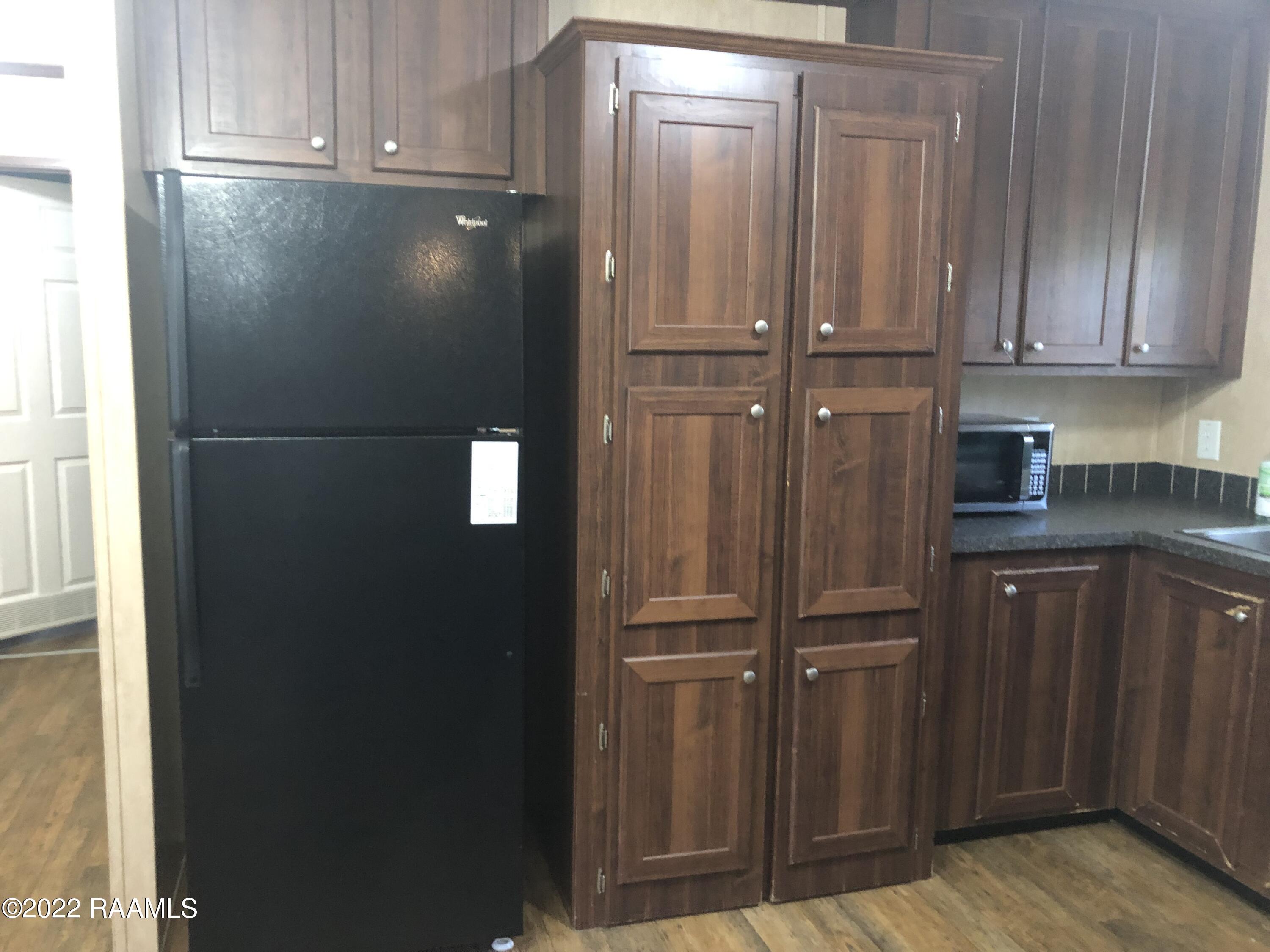 8899 Fusilier Road, Unit 16 Maurice, LA 70555 - Photo 10 of 25 surprise Cabinets next to fridge