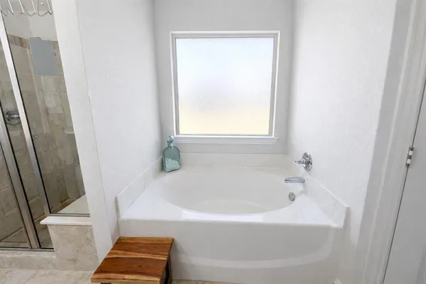 a white bath tub sitting next to a window