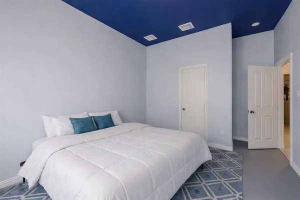 a bedroom with a bed and a night stand