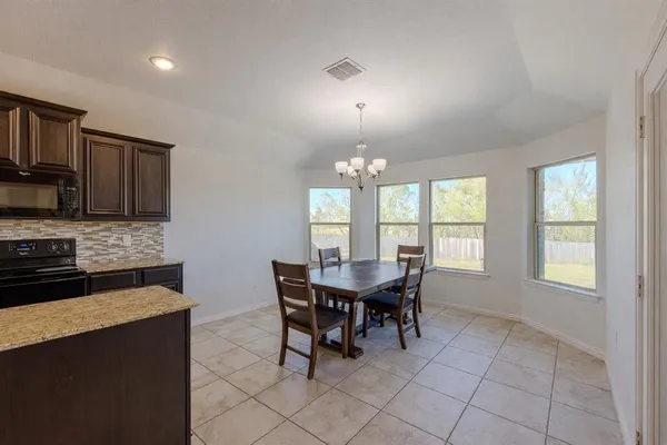 a view of a dining room with furniture and chandelier