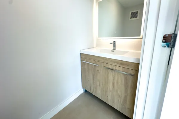 a bathroom with a sink and a mirror