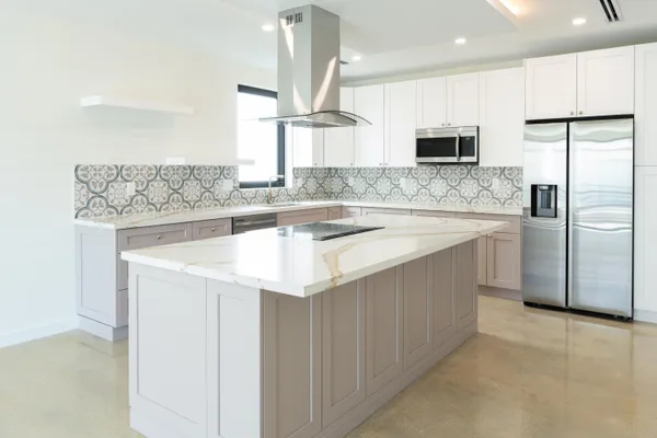 a kitchen with stainless steel appliances granite countertop a sink a stove and a refrigerator