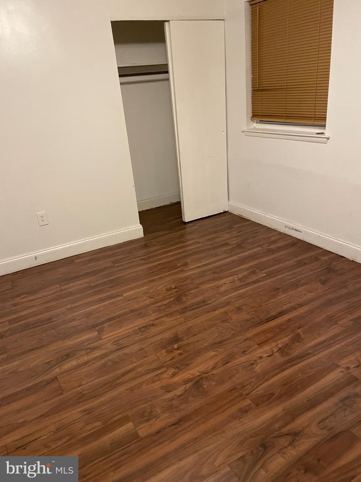 553 Foster Street, Unit 1 Philadelphia, PA 19116 - Photo 4 of 8 an empty room with wooden floor and closet