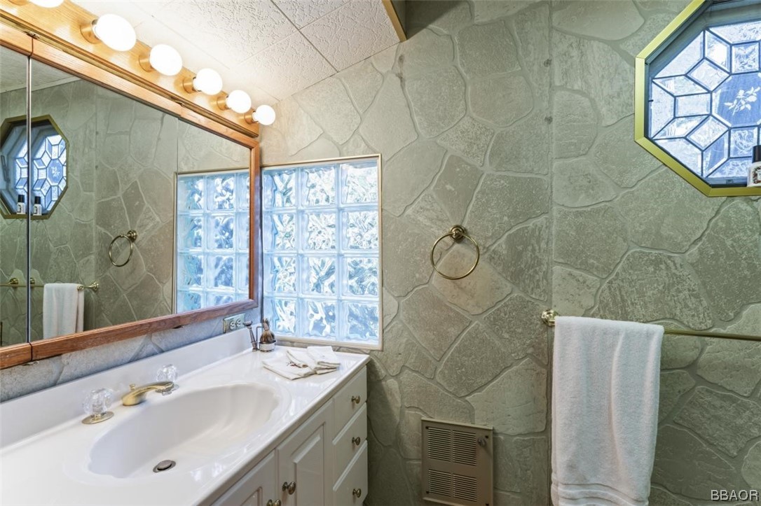 623 Highway 138 Crestline, CA 92325 - Photo 11 of 24 a bathroom with a sink a mirror and a shower