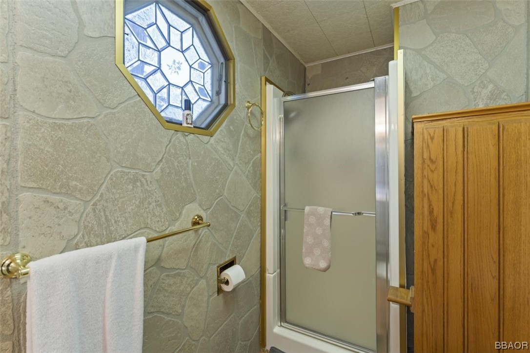 623 Highway 138 Crestline, CA 92325 - Photo 12 of 24 a bathroom with a glass shower door
