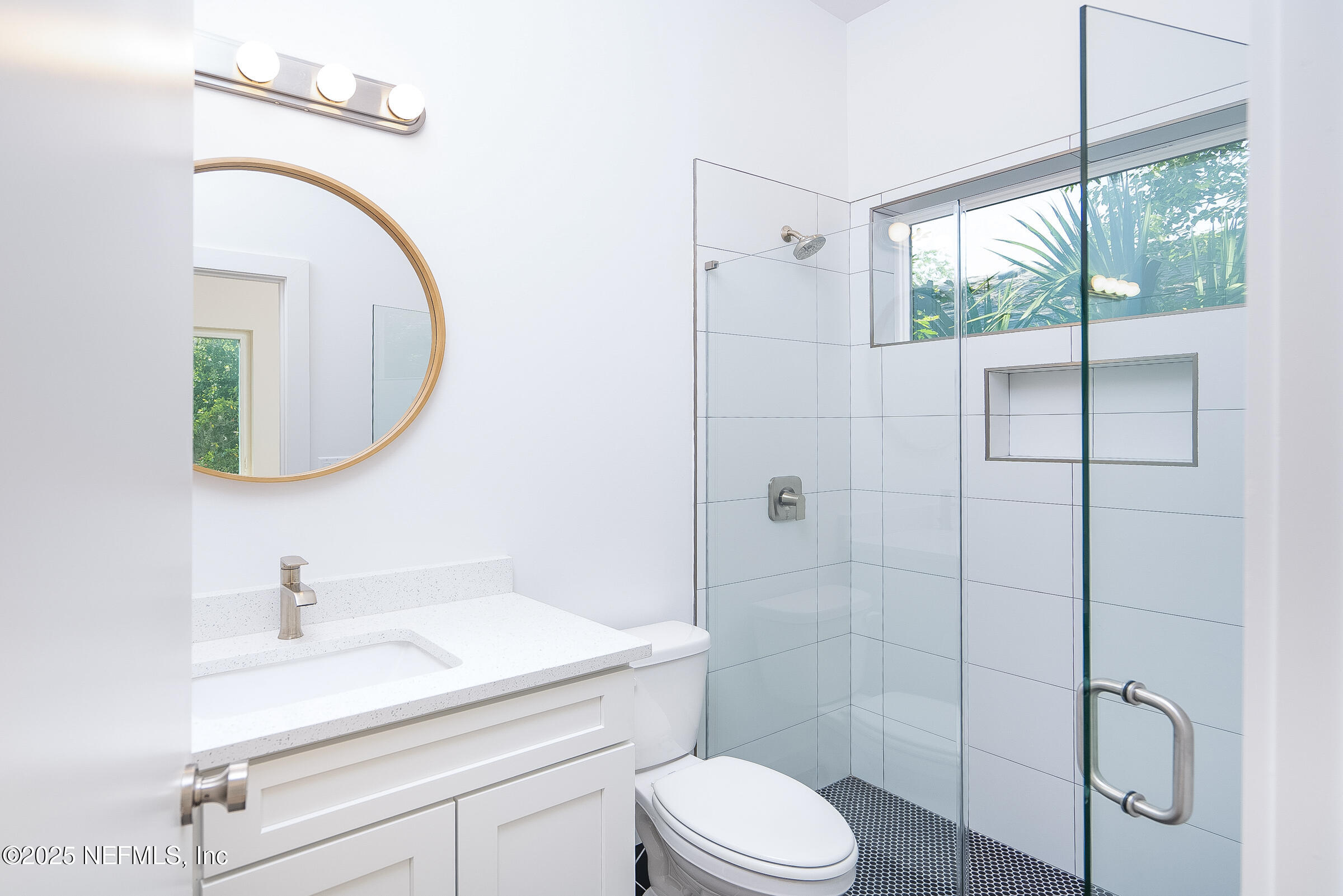 113 Ocean Boulevard St. Augustine, FL 32095 - Photo 6 of 15 a bathroom with a sink a toilet and a mirror