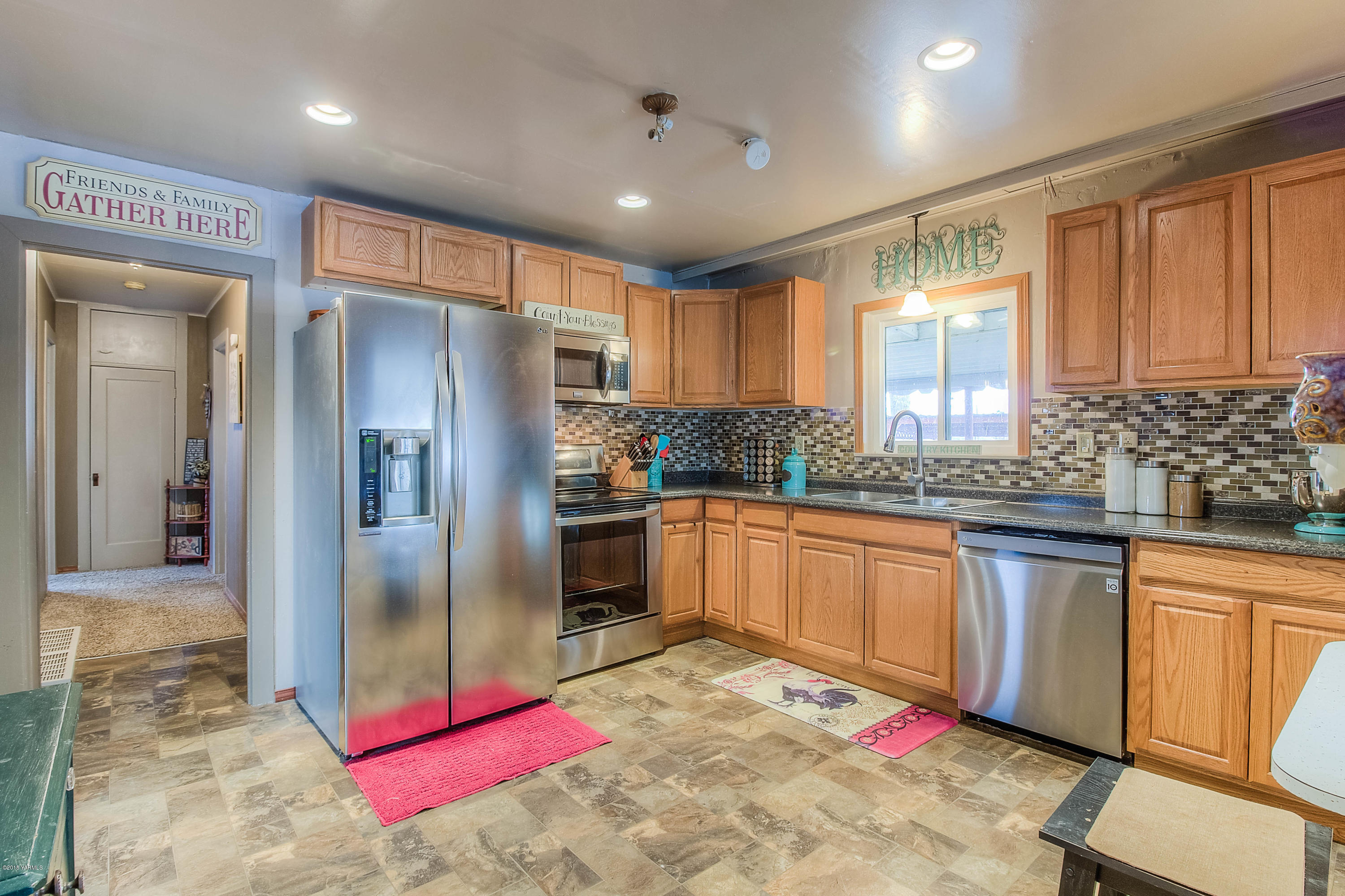 a kitchen with stainless steel appliances granite countertop a refrigerator and a sink