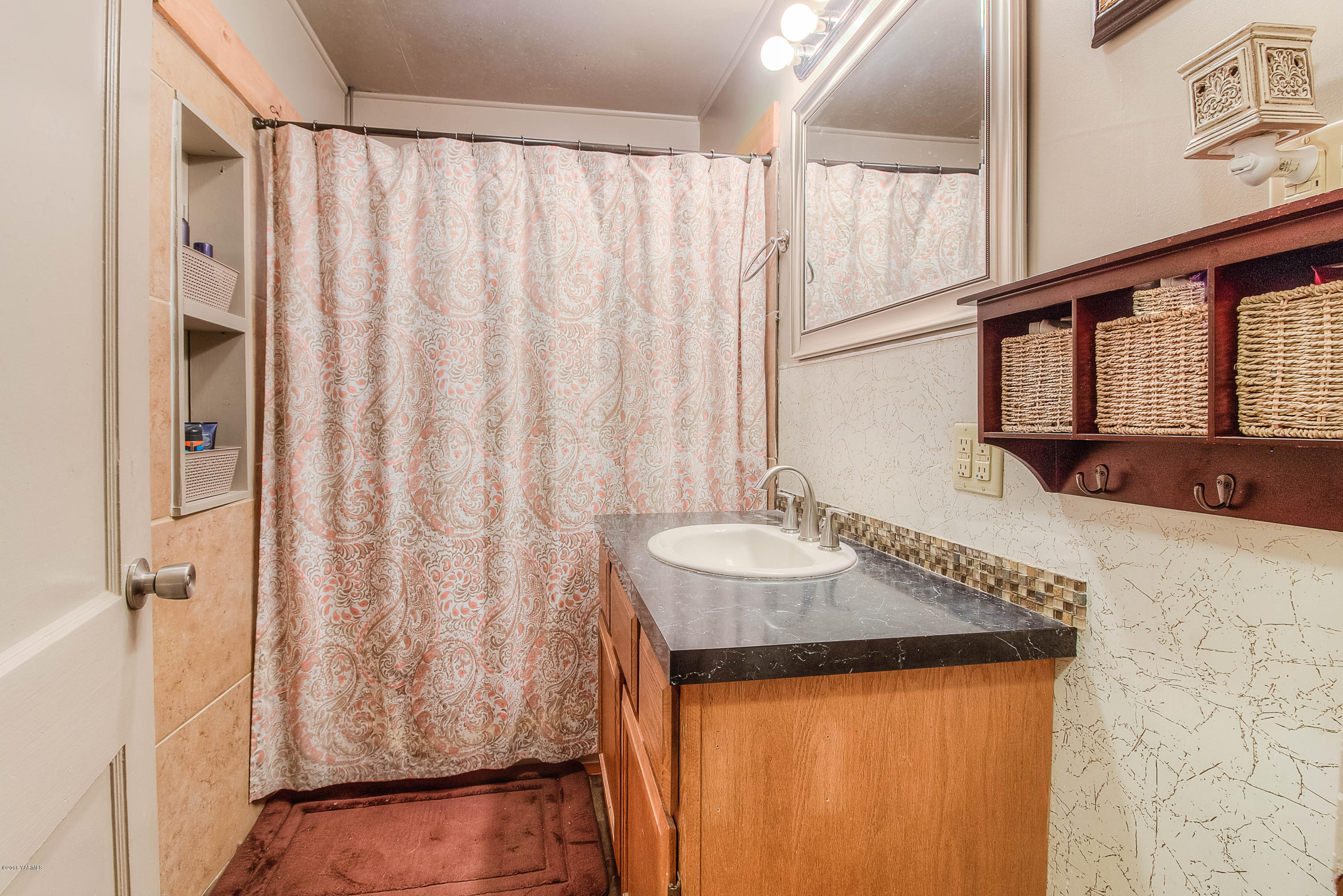 1091 Northbank Road Outlook, WA 98938 - Photo 12 of 18 a bathroom with a granite countertop sink and a mirror