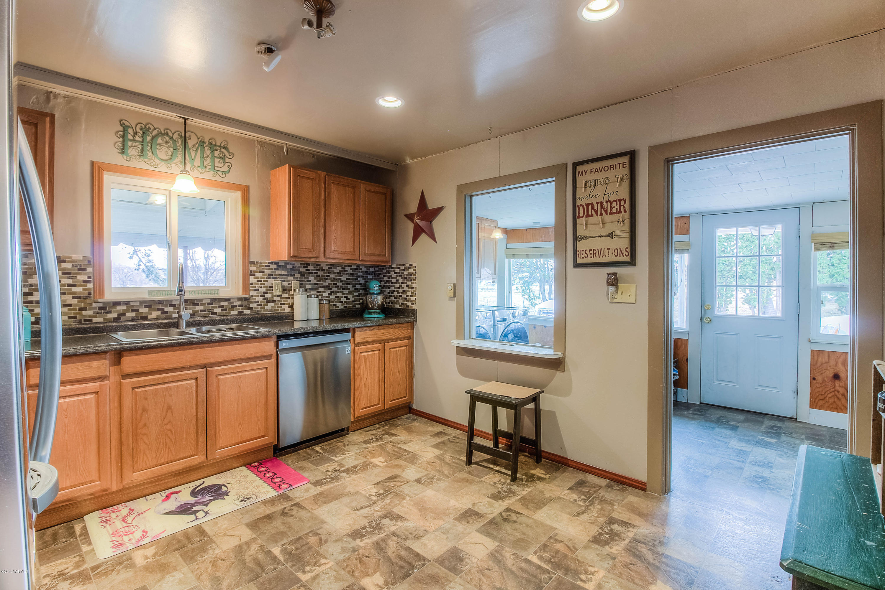 1091 Northbank Road Outlook, WA 98938 - Photo 7 of 18 a kitchen with granite countertop sink cabinets and appliances