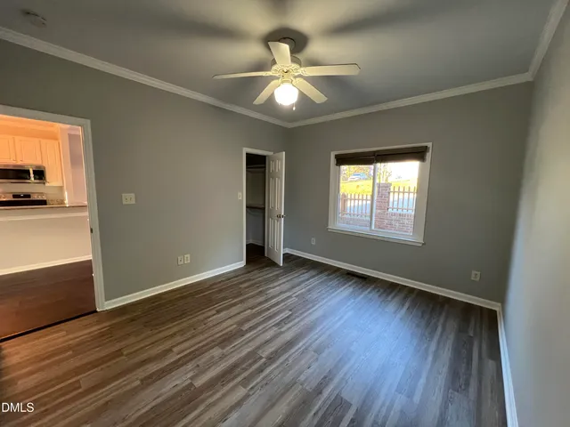 wooden floor in an empty room with a window