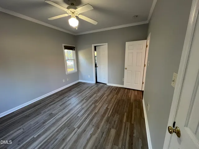 a light fixture a ceiling fan and a window