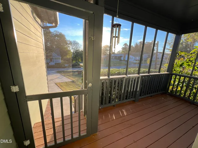 a view of a balcony with wooden floor