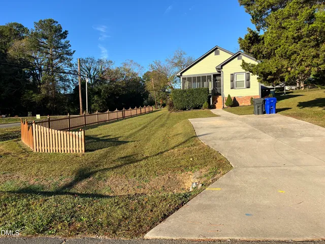 a backyard of a house with wooden floor and outdoor seating