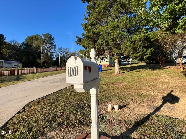 a close view of staircase with railing and a mirror