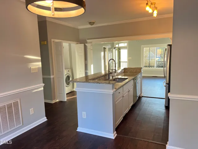 a kitchen with granite countertop counter space a sink a window and stainless steel appliances