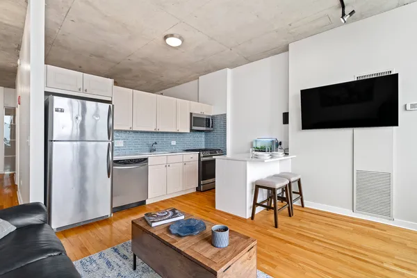 a kitchen with stainless steel appliances granite countertop a stove a sink and a refrigerator