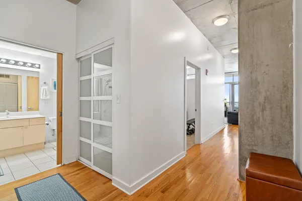 a view of a hallway and wooden floor and a living room