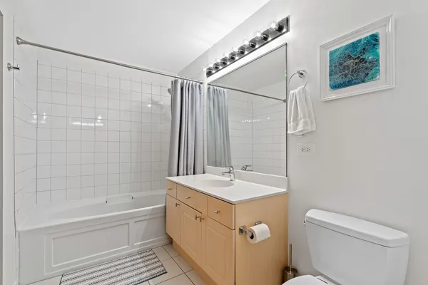 a bathroom with a granite countertop sink a toilet and shower