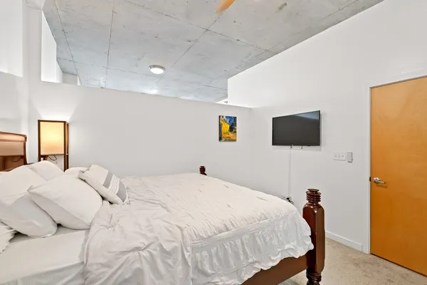 a bedroom with a bed and a flat screen tv