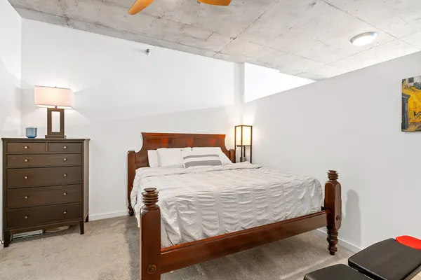 a bedroom with a bed and a lamp
