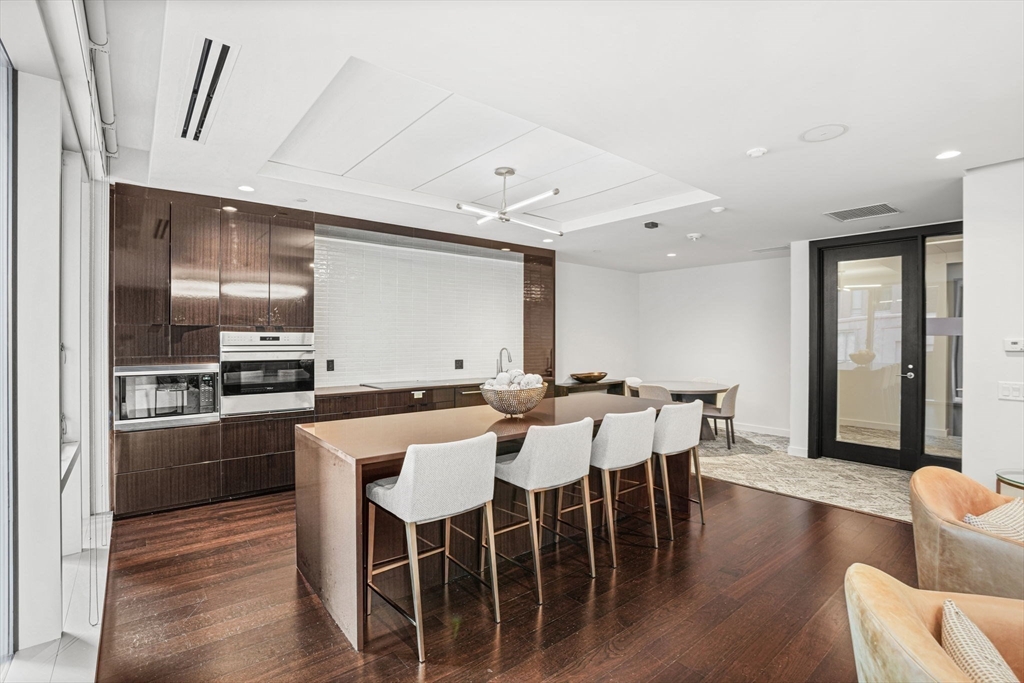 32 Traveler Street, Unit 411 Boston, MA 02118 - Photo 15 of 22 a large kitchen with a table and chairs