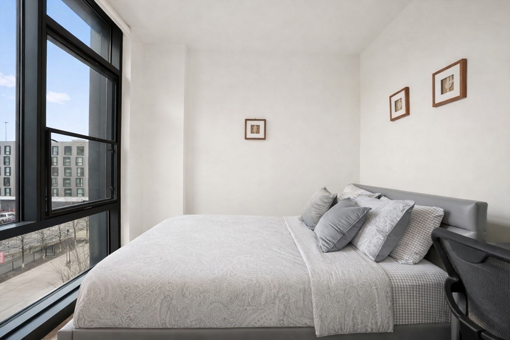32 Traveler Street, Unit 411 Boston, MA 02118 - Photo 7 of 22 a bedroom with a bed and a large window