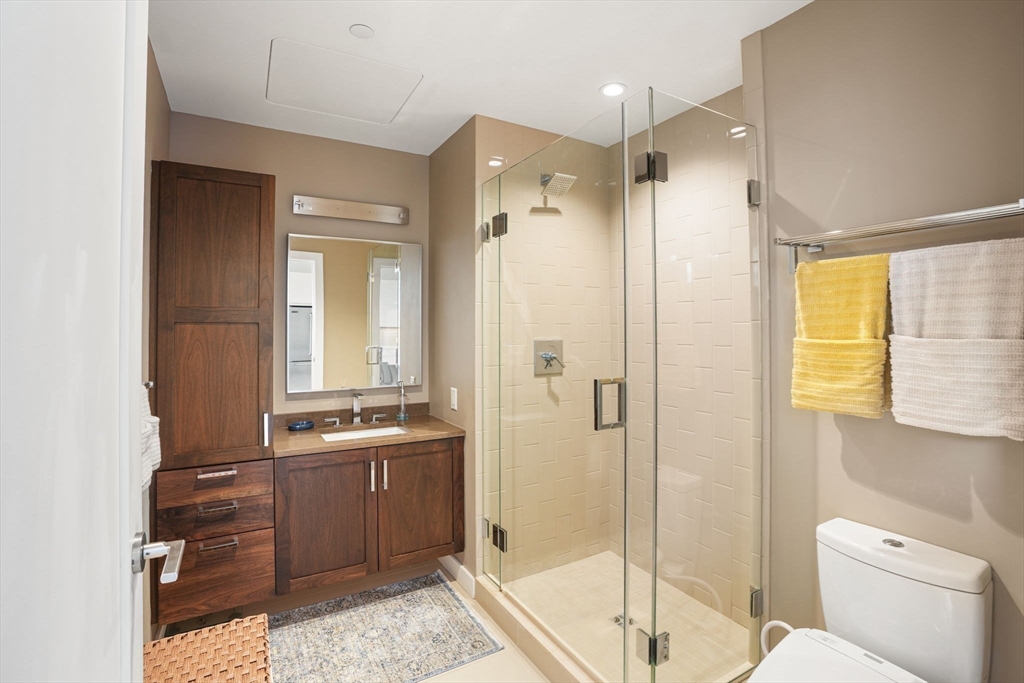 32 Traveler Street, Unit 411 Boston, MA 02118 - Photo 8 of 22 a bathroom with a granite countertop sink toilet and shower