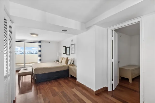 a bedroom with a bed and a desk