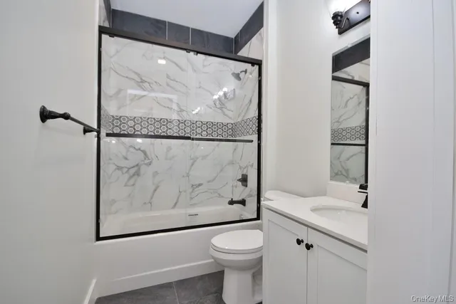 a white toilet sitting next to a bathroom sink