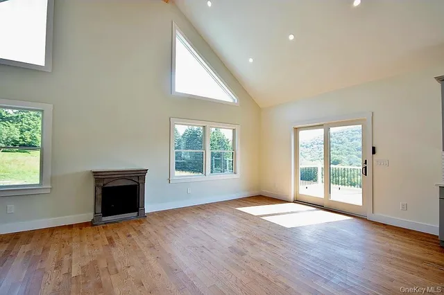 an empty room with wooden floor and a window