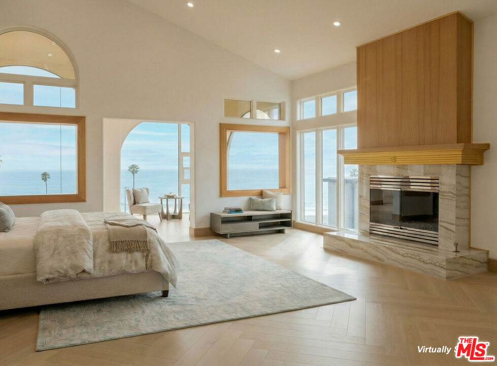 147 Napoleon Street Playa del Rey, CA 90293 - Photo 12 of 33 a spacious bedroom with a bed and a fireplace