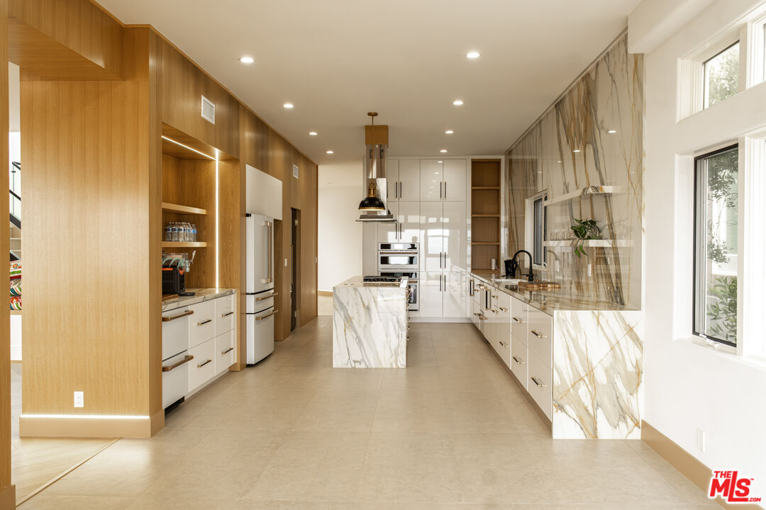 147 Napoleon Street Playa del Rey, CA 90293 - Photo 8 of 33 a large white kitchen with stainless steel appliances