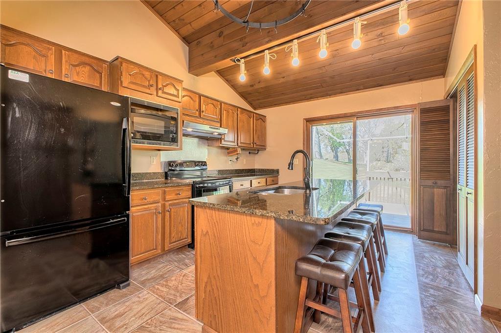 4462 Rte 286 Highway East Indiana, PA 15701 - Photo 8 of 46 a kitchen with stainless steel appliances granite countertop a refrigerator a stove and a wooden floors