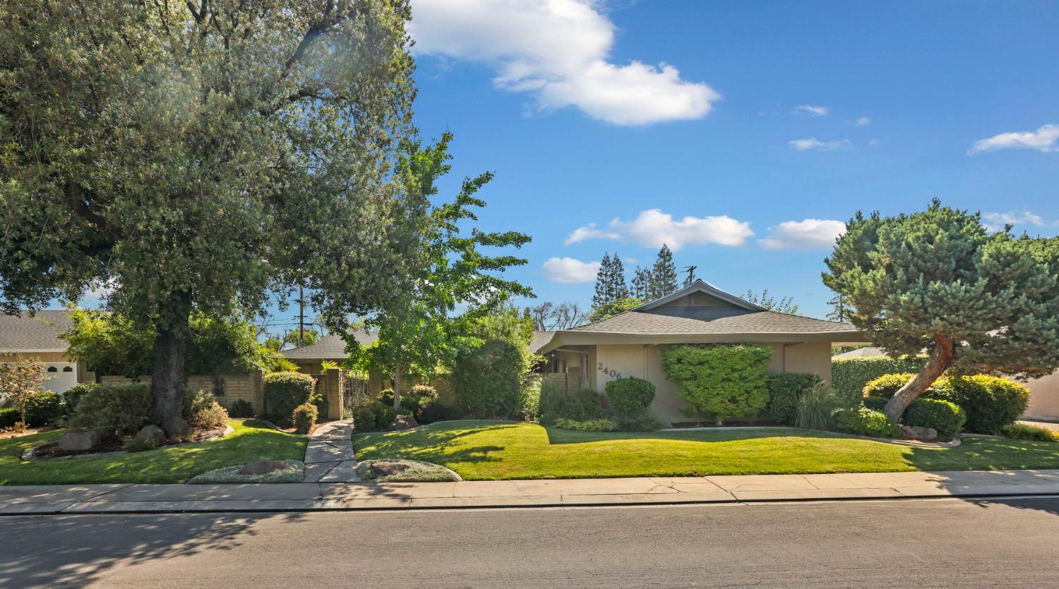 2406 Kenmore Court Modesto, CA 95350 - Photo 2 of 54 a front view of a house with a yard and garage