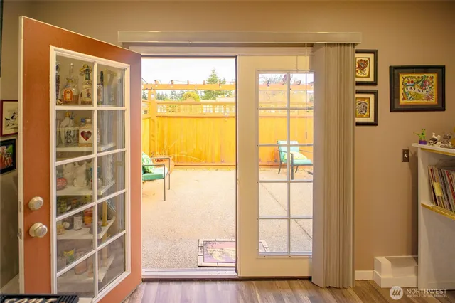 a view of a bedroom with wooden floor and windows