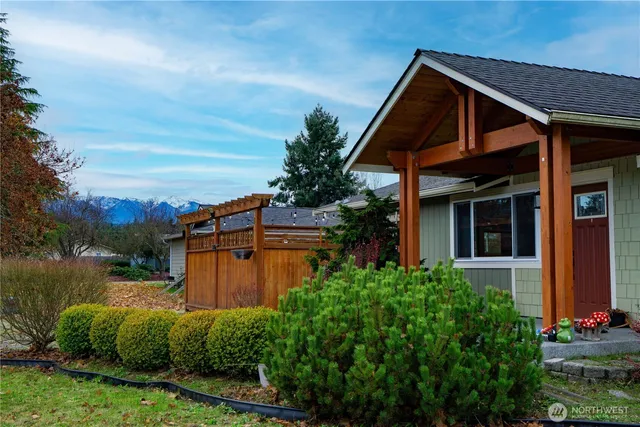 a view of backyard with deck and outdoor seating
