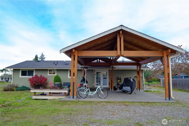 a view of a chairs and table in front of house